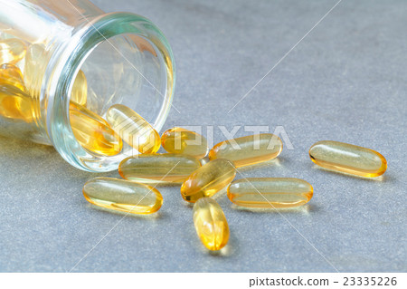 Close up capsules fish oil in Glass bottle . 23335226