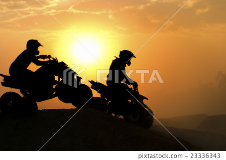 Silhouette ATV or Quad bikes Jump in the sunset. 23336343