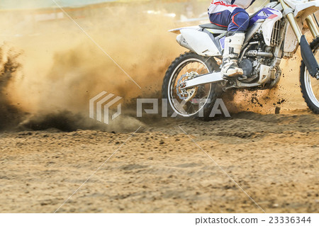 Motocross racer accelerating speed in track Motocross racer accelerating speed in track 23336344