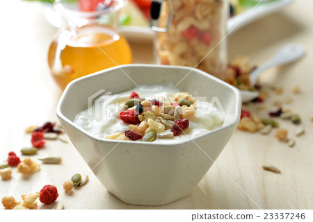 Breakfast of yogurt and cut fruit Breakfast of yogurt and cut fruit 23337246