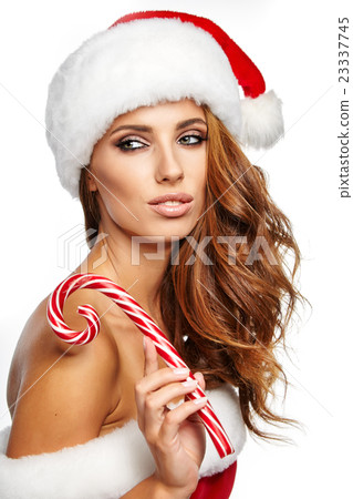 woman  holding red -white Christmas Lollipop 23337745