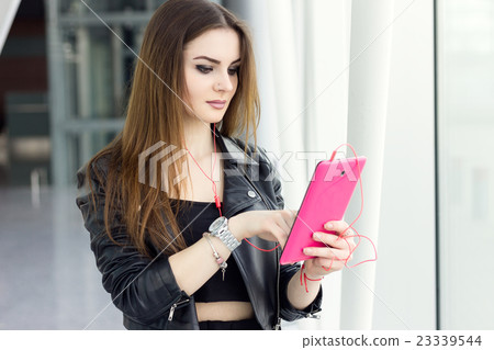 Beautiful brunette girl with tablet Beautiful brunette girl with tablet 23339544