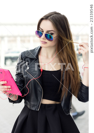 Beautiful brunette girl with tablet Beautiful brunette girl with tablet 23339546