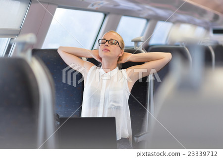 Woman streching while travelling by train. 23339712