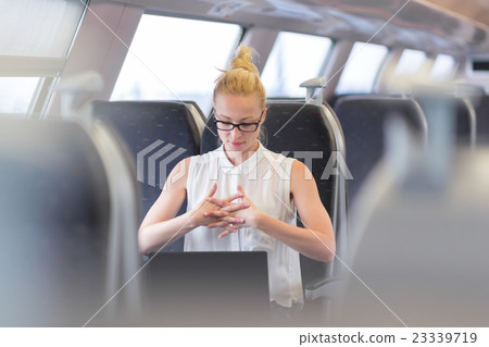 Woman streching while travelling by train. 23339719
