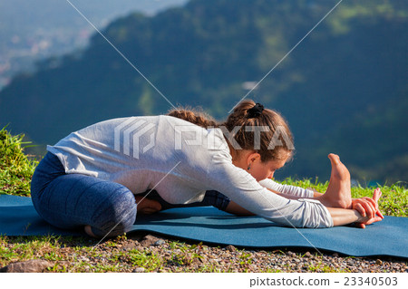 Woman doing Ashtanga Vinyasa yoga Janu Sirsasana A Woman doing Ashtanga Vinyasa yoga Janu Sirsasana A 23340503
