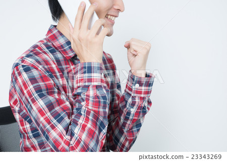 A young man talking on a smartphone 23343269