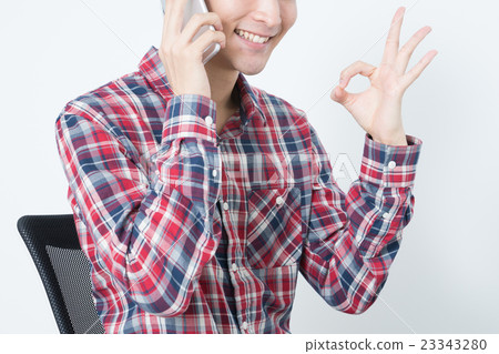 A young man talking on a smartphone 23343280