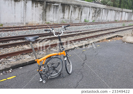 Folding bicycle parked at railroad station after r Folding bicycle parked at railroad station after r 23349422