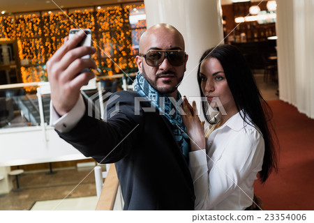 Arab businessman and girl making selfie Arab businessman and girl making selfie 23354006