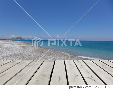 Wooden pier with blue sea, sky and beach, Greece Wooden pier with blue sea, sky and beach, Greece 23355159