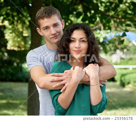 Romantic couple sit on grass in park, boy and girl 23356178