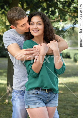Romantic couple sit on grass in park, boy and girl Romantic couple sit on grass in park, boy and girl 23356179
