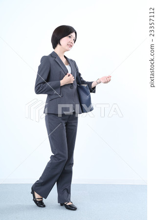 Watching a watch A woman in a suit Watching a watch A woman in a suit 23357112