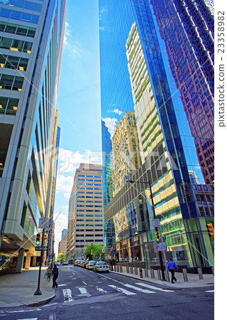 Street view with skyscrapers reflected in glass Street view with skyscrapers reflected in glass 23358982
