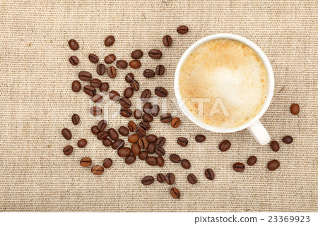 Latte cappuccino cup and coffee beans on canvas 23369923