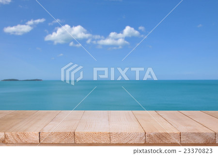 Wood table top on blurred blue sea background 23370823
