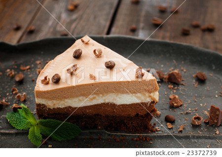 Tasty layered chocolate biscuit on black plate Tasty layered chocolate biscuit on black plate 23372739