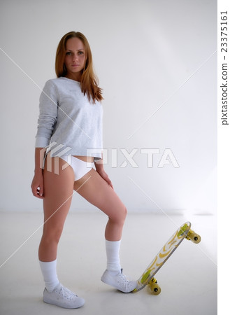 Sexy female model with yellow skateboard on white background Sexy female model with yellow skateboard on white background 23375161
