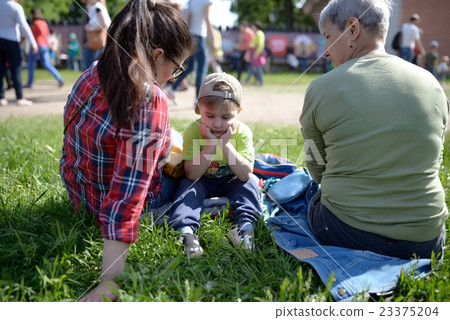 Dissatisfied little boy listens to manual of adults 23375204