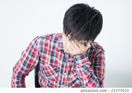 A young man holding a head A young man holding a head 23377610
