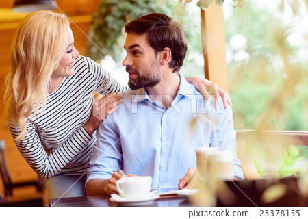 Pretty lovers having date in cafeteria Pretty lovers having date in cafeteria 23378155