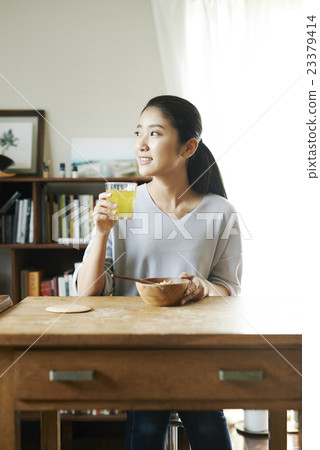 A woman drinking fresh juice A woman drinking fresh juice 23379414