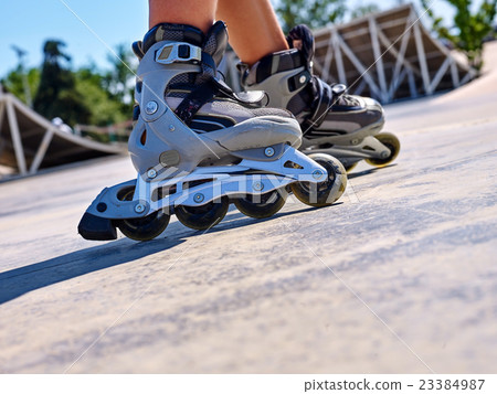 Girl riding on roller skates . Girl riding on roller skates . 23384987