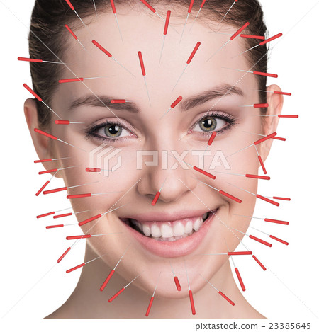Close-up of performing acupuncture therapy on face Close-up of performing acupuncture therapy on face 23385645