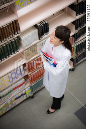 Woman in library white garment 23391101