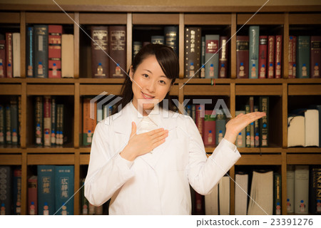 Woman in library white garment Woman in library white garment 23391276