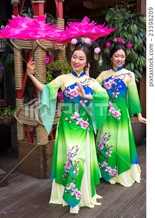 Two Chinese women in traditional oriental dresses 23398209