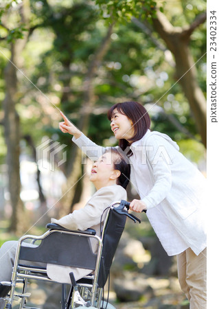 Senior female wheelchair walk 23402334
