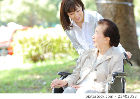 Senior female wheelchair walk 23402358