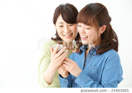 Women watching smartphones Women watching smartphones 23403005