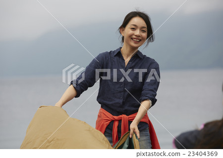 A woman holding a tent A woman holding a tent 23404369