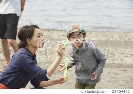 Children playing with soap bubbles 23404402
