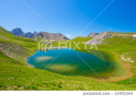 High altitude blue lake in idyllic environment High altitude blue lake in idyllic environment 23405264