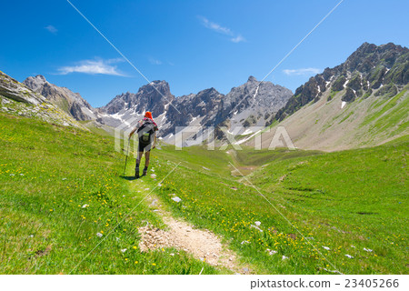 Backpacker hiking on footpath Backpacker hiking on footpath 23405266