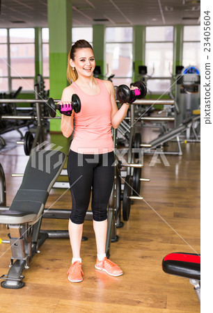 beautiful sporty woman with dumbbells 23405604