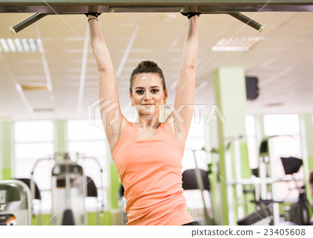 Sports young beautiful woman pulled out in the gym Sports young beautiful woman pulled out in the gym 23405608