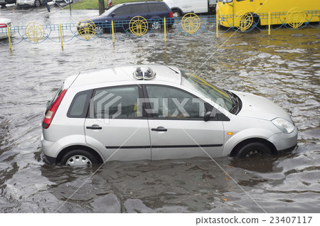 Shoes on a car roof in flooded city traffic 23407117