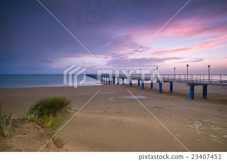 Sunset on the beach after a storm, the pier and 23407451