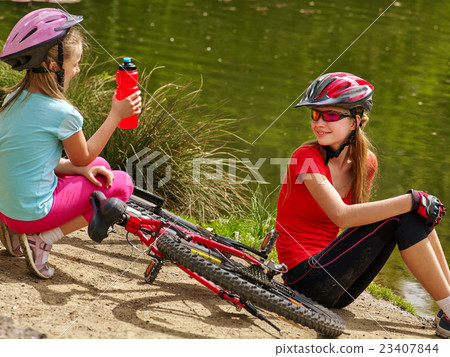 Children bicycle have rest near water in park Children bicycle have rest near water in park 23407844
