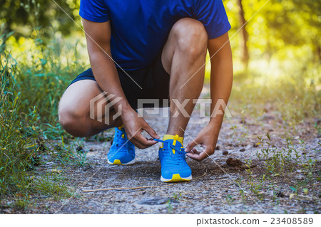 Runner tying shoelaces on sneakers. Runner tying shoelaces on sneakers. 23408589