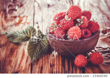 Fresh raspberry on a wooden table 23408590