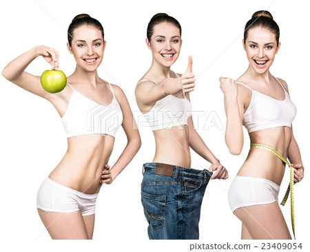 Woman holds green apple and measuring tape. 23409054
