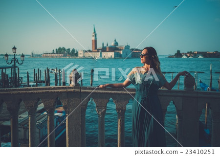 Beautiful well-dressed woman standing near San Beautiful well-dressed woman standing near San 23410251