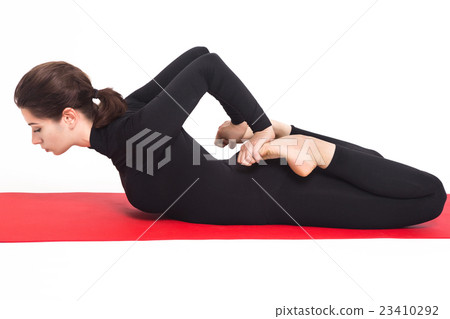 Beautiful athletic girl in black suit doing yoga 23410292