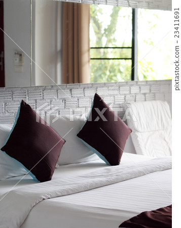 blue brown color pillows in white painted bed room 23411691